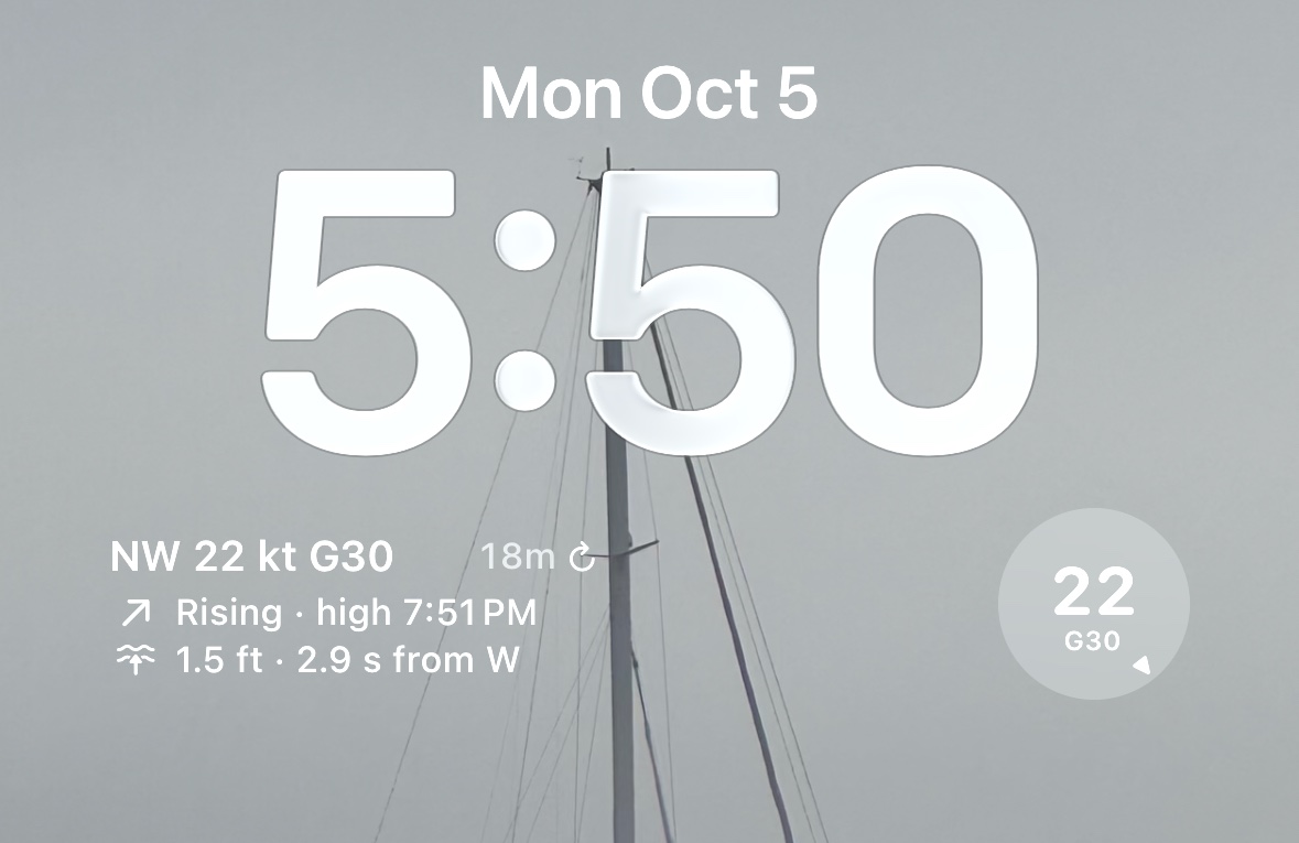 An iPhone lock screen with the SailTools rectangle widget under the clock and the wind dial beside it.